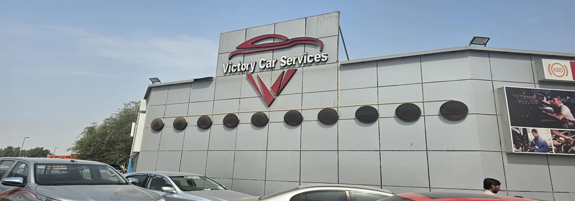 The Victory Car Services building with its red chevron sign in Ras Al Khor, Dubai