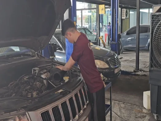 Technician working under an open bonnet